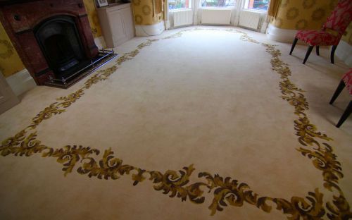 Hand tufted carpet with floral border