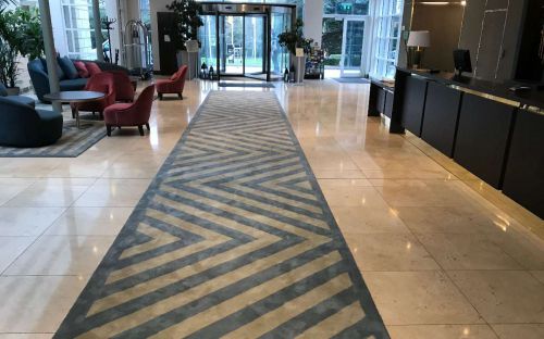 Hand tufted runner with chevron design in hotel lobby