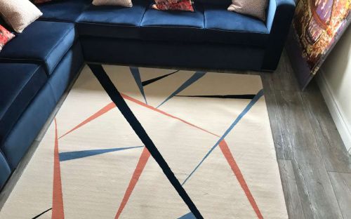 Hand tufted cream rug with colourful chards design