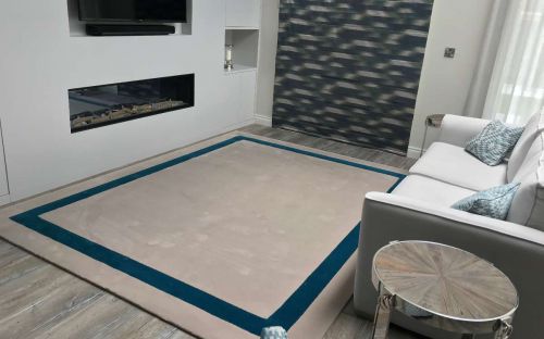 Hand tufted cream rug with teal border