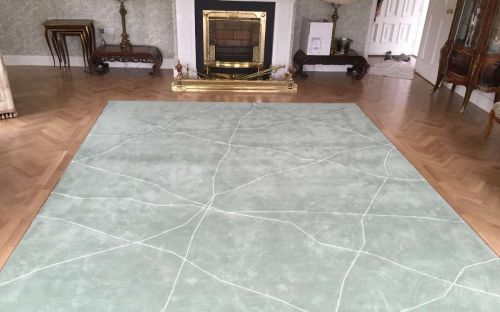 Hand tufted mint green rug with cracked white lines